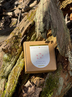Small brown box with a label on a textured wooden surface