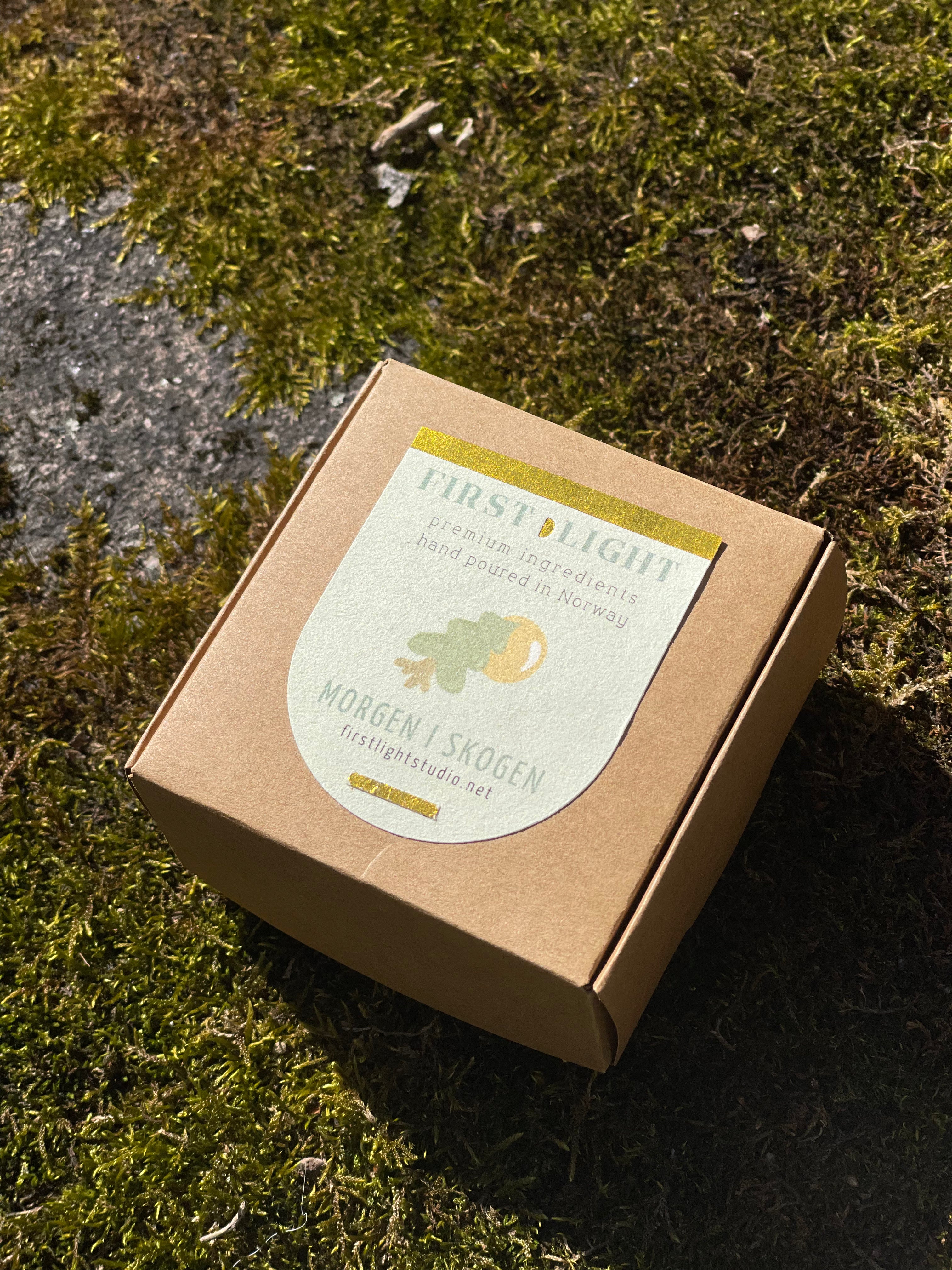 Brown cardboard box with a label on a mossy surface