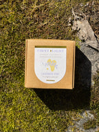 Small cardboard box with a label on a mossy surface